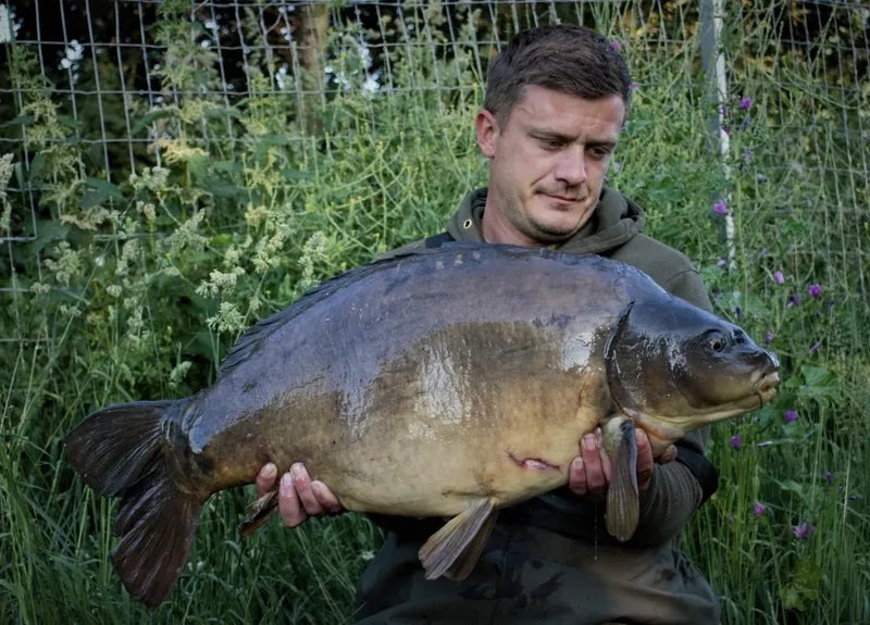 NX Baits sponsored angler Daniel Nose proudly displays a large fish caught using NX Baits Scopex Peach range - showcasing the effectiveness of the bait