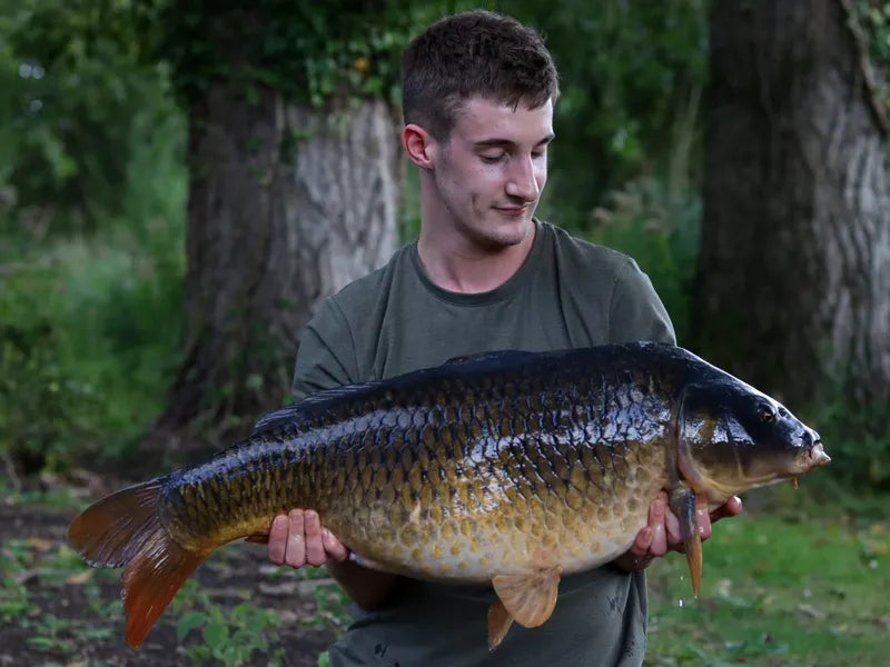 NX Baits sponsored angler Michael Ogden proudly displays a large fish caught using NX Baits Scopex Peach range - showcasing the effectiveness of the bait.